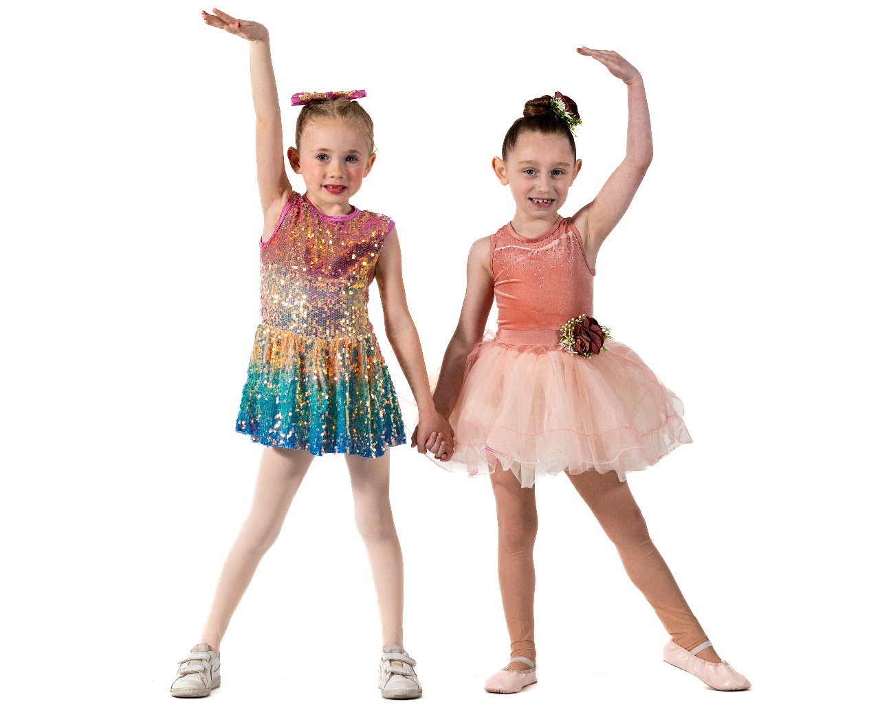 Two Symmetry Dance Company students in colorful costumes for the Apprentice program ages 7-9