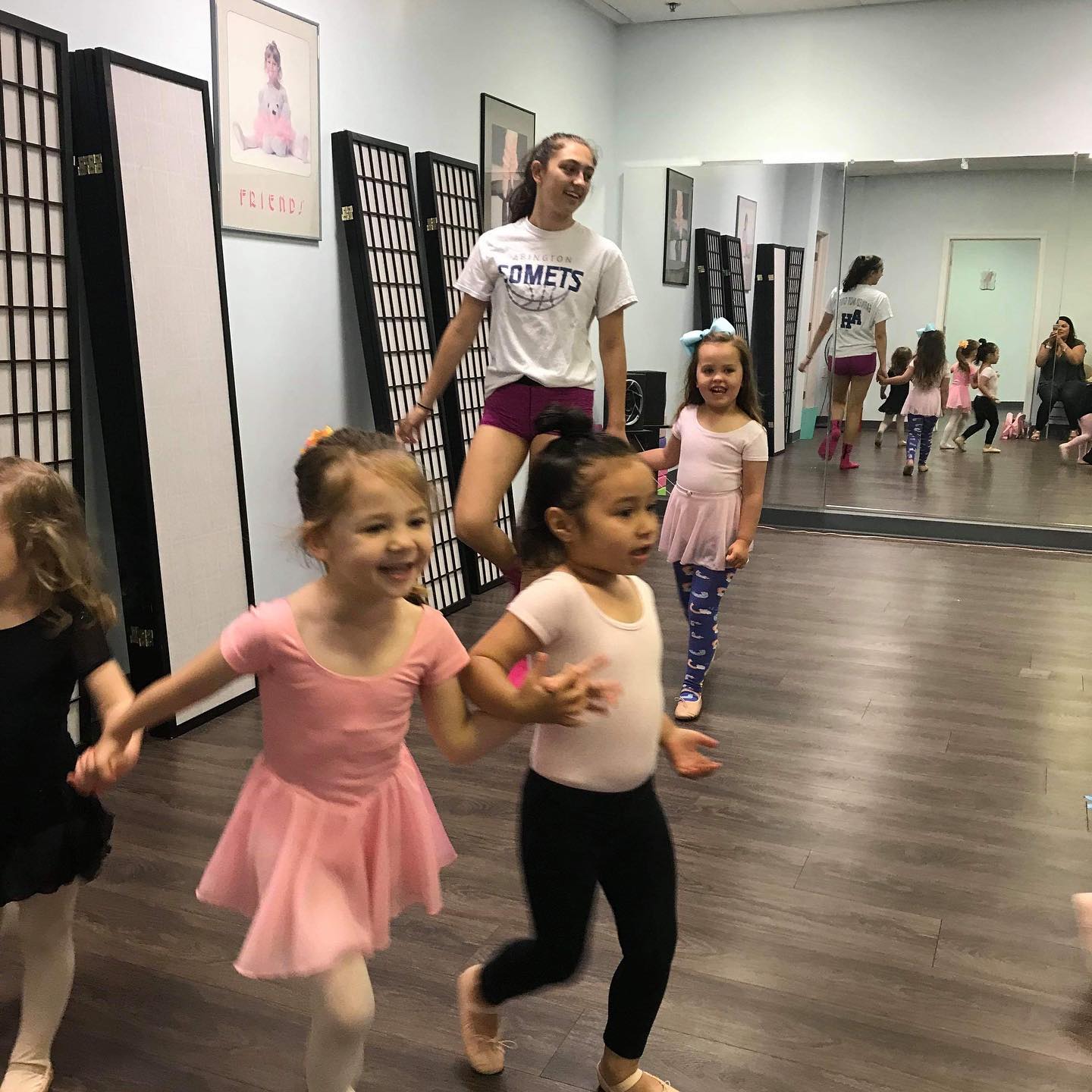 Children ages 1.5-4 in the First Steps program at Symmetry Dance Company running and laughing during ballet class