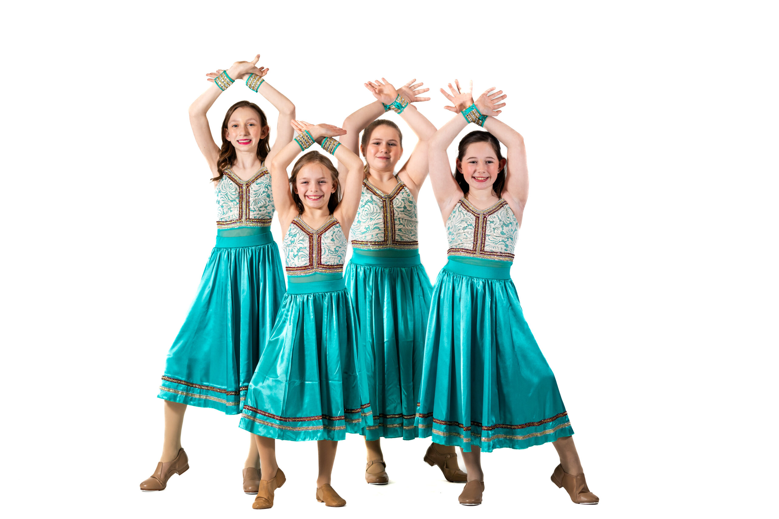 Symmetry Dance Company students in colorful blue costumes for the Junior Company