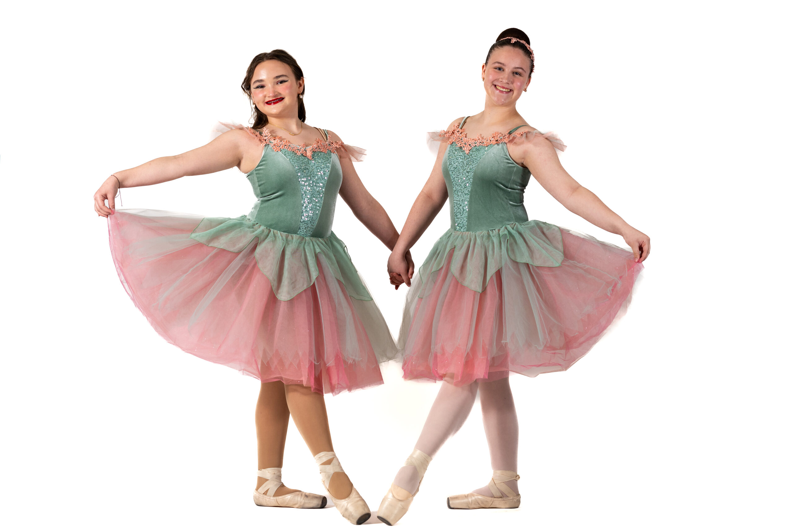 Two Symmetry Dance Company dancers in pink and green ballet costumes for the Principal I program