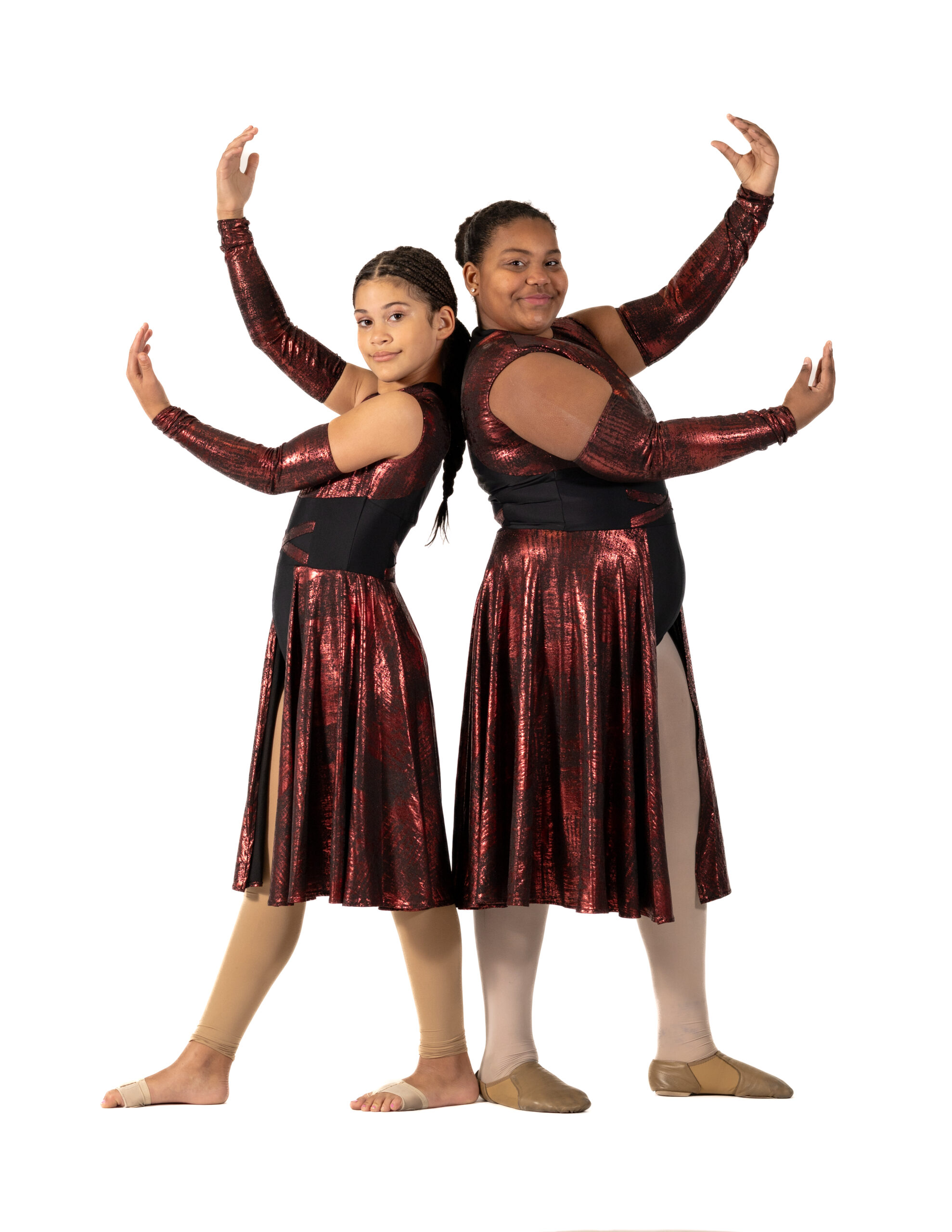 Two Symmetry Dance Company dancers pose in red costumes for the Sophomore program