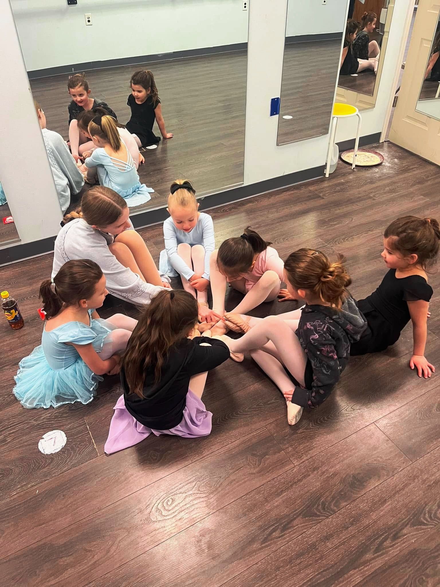 Young ballet students sit in circle in dance class at Symmetry Dance Company in Scranton PA