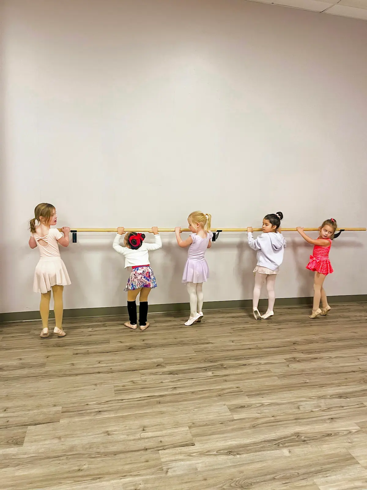 Young dancers practicing at ballet bar in toddler ballet class in Scranton, PA