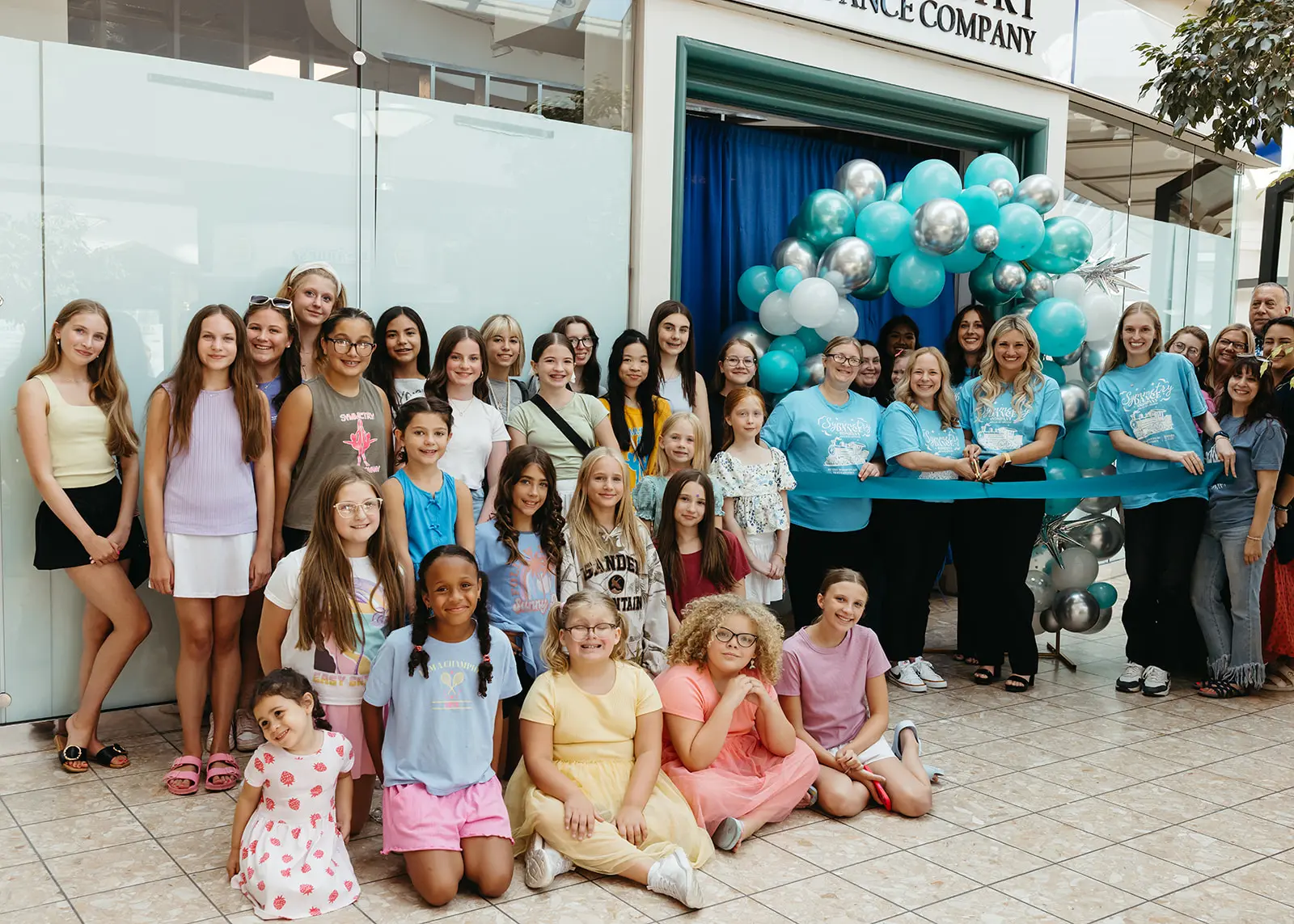 Group of Symmetry Dance Company students and teachers at the studio ribbon cutting in Scranton, PA
