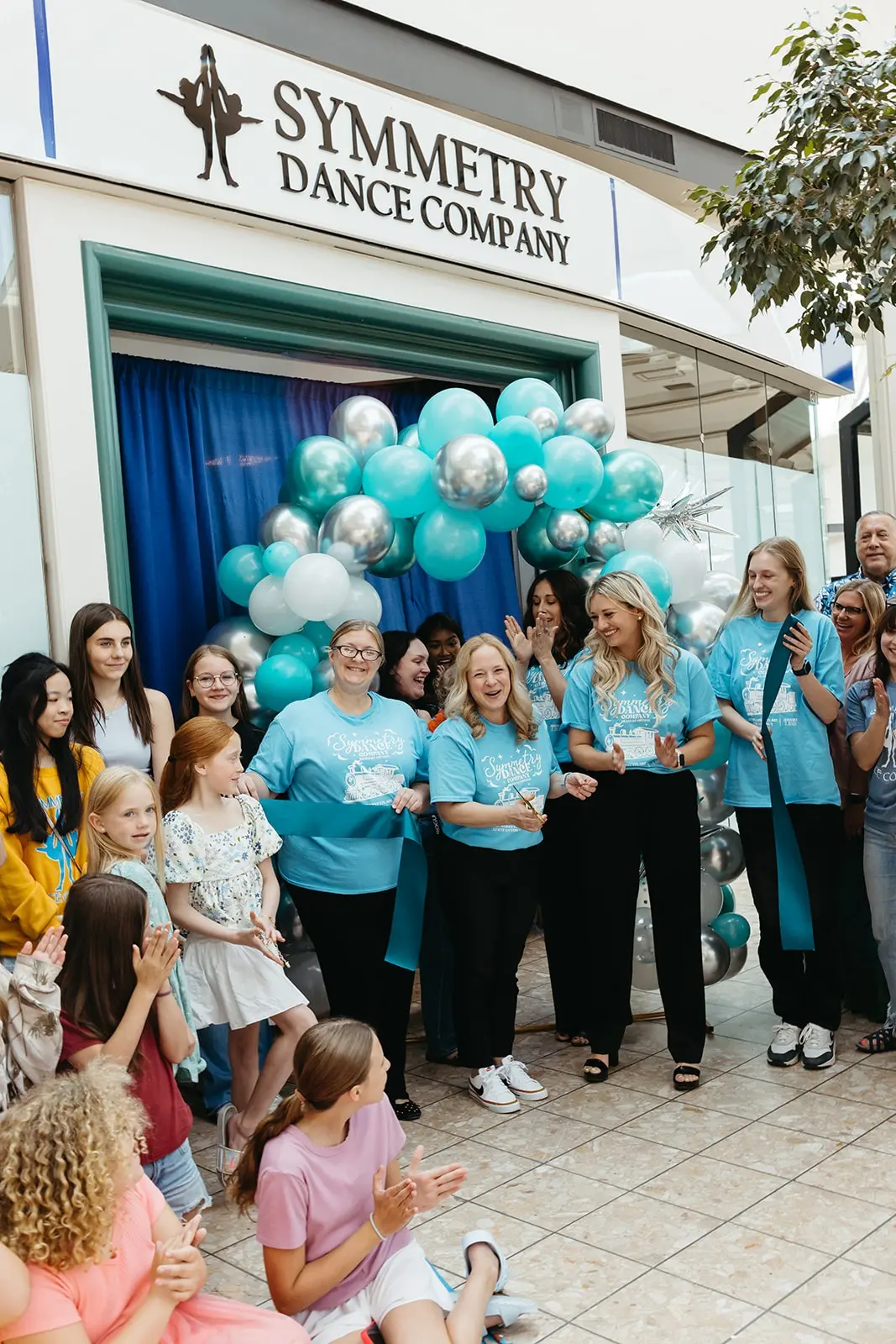 Symmetry Dance Company directors Abby Slater and Blythe Alexander celebrating the grand reopening of their Scranton, PA dance studio with staff and students